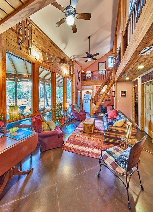 Lodge:  Architecturally magnificent Living Room, Kids Nook & out floor-ceiling windows to outside living area & woods. Glance up to loft & right to bedrooms doors. Click link in photo for video walk-thru & floorplans.