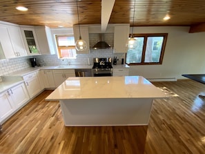 Brand new kitchen with quartz countertops and new appliances.