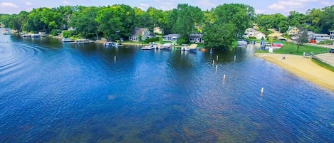 View of the lake and beach looking west from the house with the public beach.