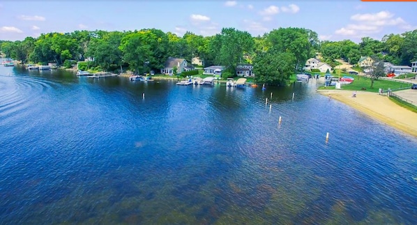 View of the lake and beach looking west from the house with the public beach.