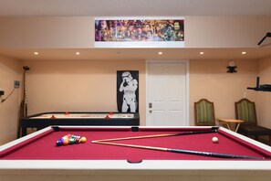 Fun-filled game room with a pool table and unique art for your entertainment.