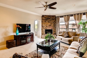 Living room features a gas fireplace, patio access and mountain views.