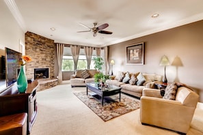 Living room features a gas fireplace, patio access and mountain views.