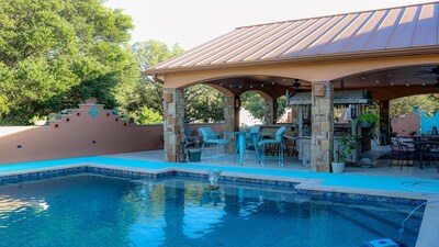 Pool beside enclosed back patio  Bar & grill area