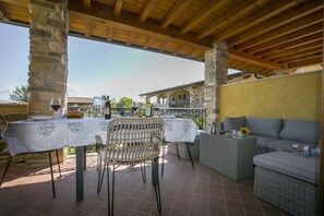 The covered terrace for some relaxing and dining table.