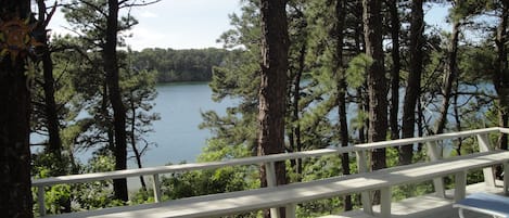 Deck overlooking white pond with seating around perimeter