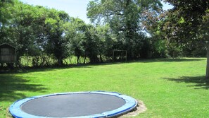 Sunken trampoline in shared garden at Les Hiboux gites
