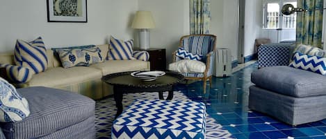  Big comfortable chairs sofa and ottomans make this a lovely blue and white room