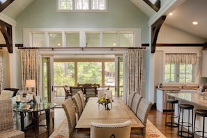 The large sliding windows open up the dining room to the screened in porch.