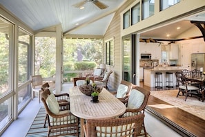 The large glass doors recede into the walls to enlarge the entertaining space