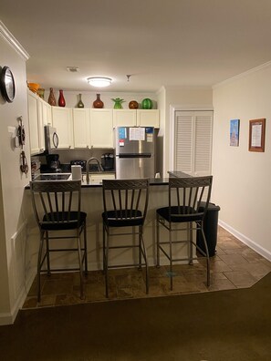 Kitchen with bar seating for 3. 