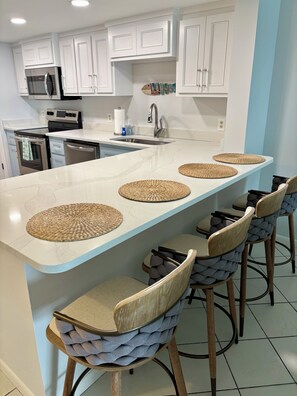 Open kitchen with bar seating for 4 featuring swivel stools