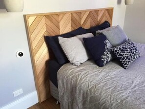 Master bedroom with gorgeous handmade bed head