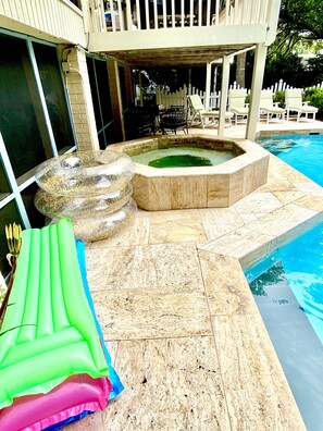 Beautiful marble travertine wraps itself around the private pool and hot tub 