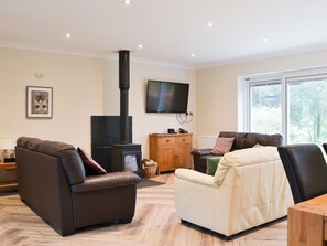 Warming wood burner within living room | Lucy&rsquo;s at the Grange - Grange Country House Holiday Cottages, Loweswater, near Cockermouth
