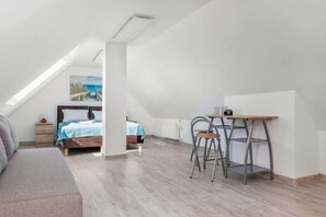 A spacious bedroom with a double bed and sofa bed creates the perfect space for relaxation. In addition, a desk o chair provides a comfortable place to study. 