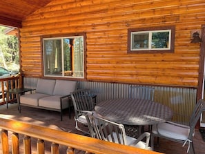 Front deck with table, couch, BBQ, ice cooler and more...