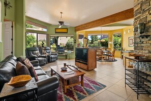 Spacious open plan living with comfy couches and recliners