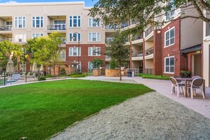 The building's grassy courtyard is a great spot for a relaxing stroll