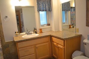 Shared Bathroom - Large vanity, shower/tub combo, laundry