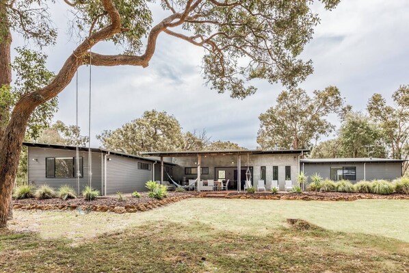 Four acres of native bushland surround the home, offering space to roam and the chance to spot friendly kangaroos at dawn.
