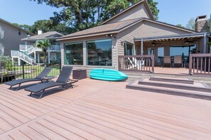 Full view of the massive deck leading out to private slip with boat lift.