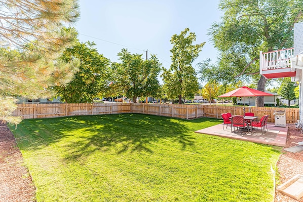 Large grassy fenced in yard and patio area- perfect for families!