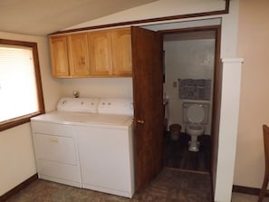 The utility area and doorway to the bathroom is just inside the entryway.