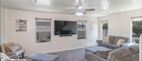 Gather in the Living Area to Watch your Favorite Show on this Large Smart TV