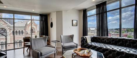 Floor-to-ceiling windows surrounding the unit on the lower level