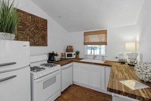 Quaint kitchen with butcher block countertops & lake view from the window over the sink