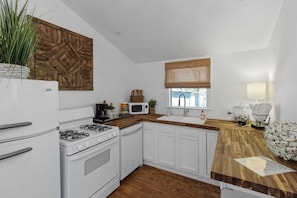 Quaint kitchen with butcher block countertops & lake view from the window over the sink