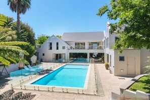 Heated swimming pool and view of the house