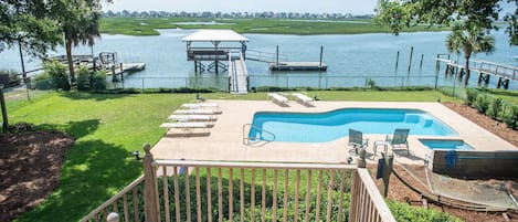 View from the Large screened-in back porch overlooking the dock, pool & hot tub.