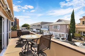 We love the balcony....don't you? Enjoy breakfast, a meal, or drinks outside while watching the people below. This balcony faces west for sunsets!