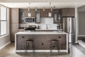 Kitchen appliances include a full-size fridge and dishwasher