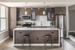 Kitchen appliances include a full-size fridge and dishwasher