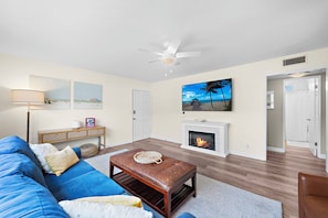 The living room has a 70" smart TV for movie night. Over 10 streaming services, live sports. and 200+ movies in our Amazon library.