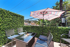 The private outdoor patio has a gas grill and chairs. This balcony almost counts as shared space as you will likely hear the guests below in the backyard