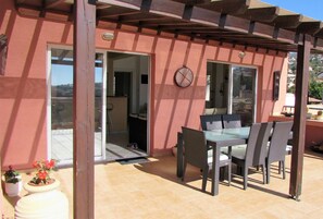 Terrace. Table underneath pergola