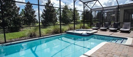 Private pool with jacuzzi spa and lounge chairs.