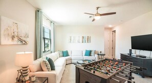 The stairs lead to the living room on the first floor which is impeccably furnished, complete with a TV and a Football table!