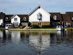 Wherry Cottage (centre) surrounded by gardens on 3 sides and best river views..