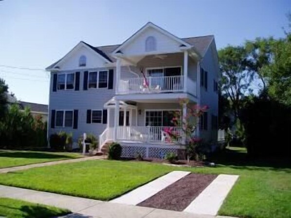 Front of House. 1St floor deck is now screened-in. Landscaping has been improved