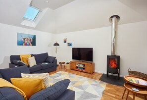 The Larches, St Agnes. Ground floor: Sitting room with smart television, cosy wood burning stove and french doors