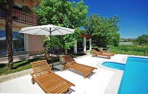 Sunbeds under the parasoles for taking rest from swimming