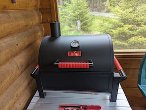 Portable charcoal grill that can be used on the beach