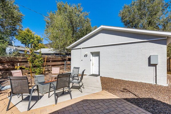 Shared patio with a gas fire pit outside of the studio