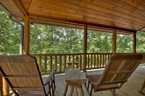 Relax & unwind under the covered wrap around porch