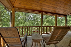 Relax & unwind under the covered wrap around porch